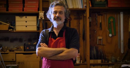 The professional violin master makes a violin with his own hands, uses a clean tree spruce, pine, glasses, planes, tunes strings. Concept: spiritual instrument, hand made, art, music, melody, sound. - Powered by Adobe