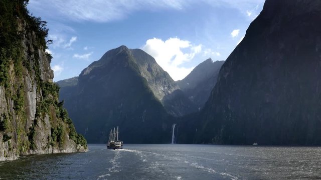 NEW ZEALAND – MARCH 2016 : Video shot of Milford Sound fiord from a boat on a beautiful day with mountains and boat in view