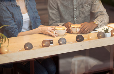 Close up of two cups that standing on the wooden table