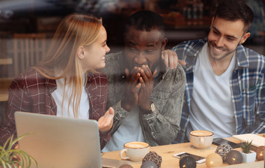 Happy African man covering his mouth