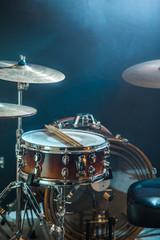 Obraz na płótnie Canvas musical instruments drum kit, flash of light, a beautiful light in the background with copy space