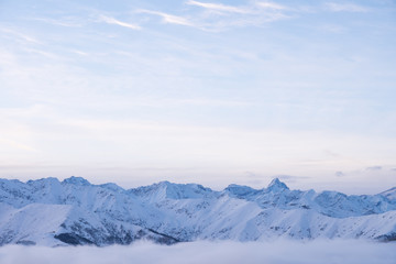 Fototapeta na wymiar Winter panorama of Italian Alps with snow and fog