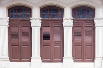 Old classic window frames in Chinatown district of Singapore