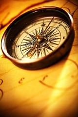 Close up view of the compass on old paper