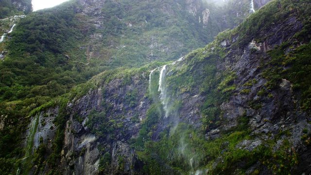 NEW ZEALAND &ndash; MARCH 2016 : Video shot of Milford Sound waterfall on a beautiful day from a boat with mountains in view
