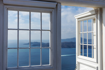 Open door with view of the Mediterranean Sea in Oia, Santorini