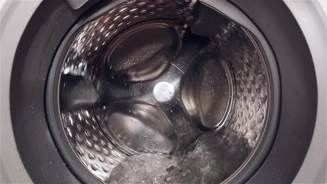 HD - Camera moves to inside the washing machine. Slow-mo