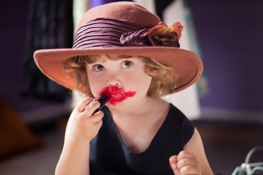 Little Girl Trying Mothers Lipstick. Growing Up Concept.