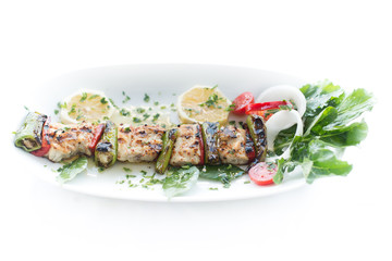 Grilled fish shish kebap with vegetables on isolated background