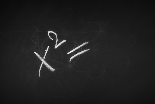Mathematical equation, formula symbol, sign on chalkboard, blackboard texture