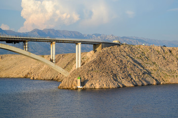 Bridge at rocky coast during sunset