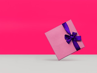 Gift box Trendy styled photo Light lilac gift box with purple ribbon is hanging in the air on the...
