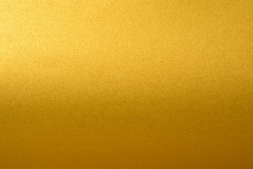 Details of golden texture background with gradient and shadow. Gold color paint wall. Luxury golden background and wallpaper. Gold foil or wrapping paper.
