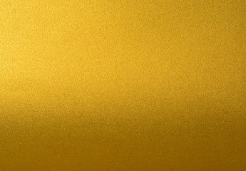 Details of golden texture background with gradient and shadow. Gold color paint wall. Luxury golden background and wallpaper. Gold foil or wrapping paper.