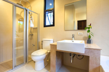 Fototapeta na wymiar Luxury bathroom features basin, toilet bowl and bathtub
