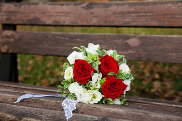 Beautiful wedding bouquet on the bench in the park