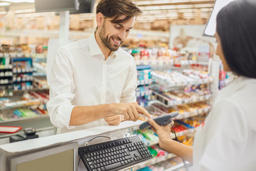 Man buying food products in the supermarket shopping