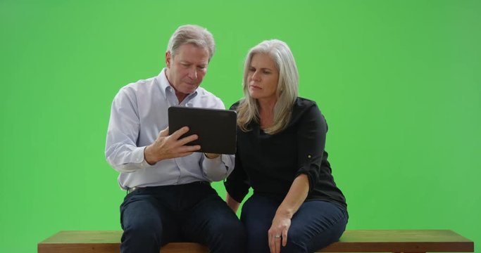 Good looking caucasian couple reading a tablet computer