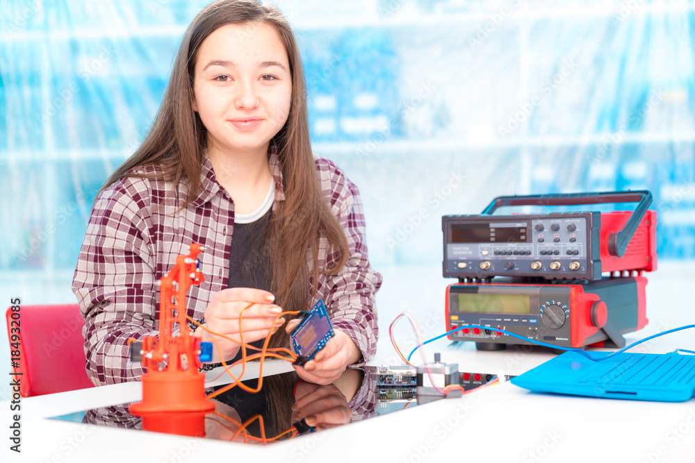 Poster Schoolgirl in laboratory robots debug microcontroller