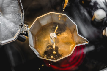 Obraz na płótnie Canvas Italian Aluminum Coffee Maker Brewing a Fresh Dark Coffee on the Stove