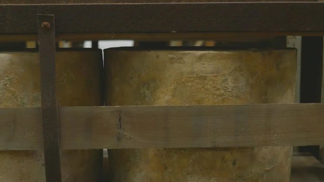Many moulding cheeses aging for taste in cheese factory cathedral