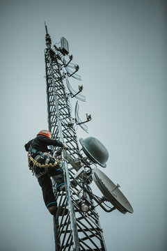 Telecom Worker Climbing Antenna Tower