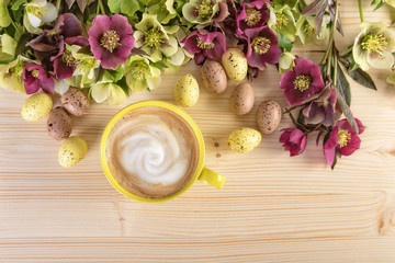 Cappuccino cup and  flowers with Easter eggs