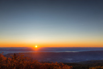 Morning dark sunrise with sky and golden yellow orange autumn foliage in Dolly Sods, Bear Rocks, West Virginia with overlook of mountain valley