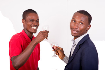 two happy men toast with glasses of wine