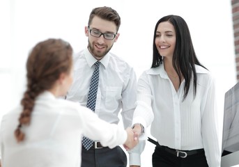 young business woman shaking hands with a colleague