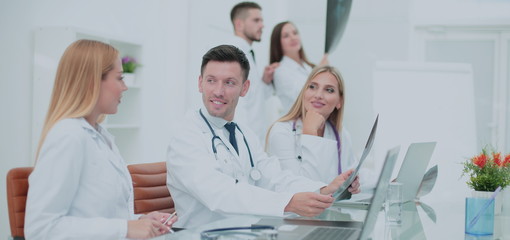 Fototapeta premium Workflow in the clinic. Doctors communicate and analyze an X-ray