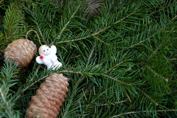 Toy angel against fir-tree branches