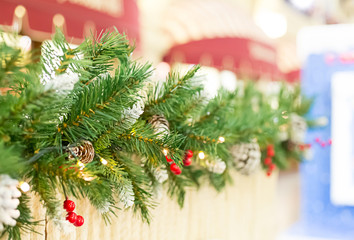 border Christmas tree branch cone with bright berries holly street festive Christmas decoration with perperktive and copy space