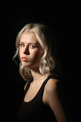 Fototapeta premium Calm girl with white hair and natural makeup on dark background