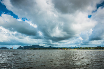 Fototapeta na wymiar Dark water with dramatic sky on the background over the ocean near Thailand
