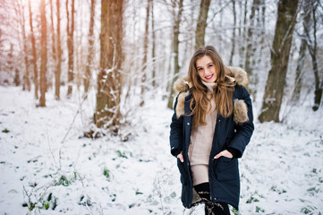 Fototapeta na wymiar Beautiful brunette girl in winter warm clothing. Model on winter jacket.