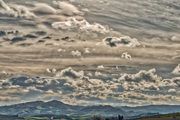 cloudy sly on cultivated fields in badlands