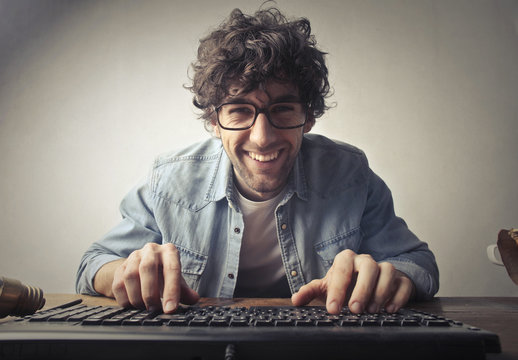 Smiling man using a pc