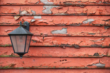 Street lamp on grungy red wooden wall
