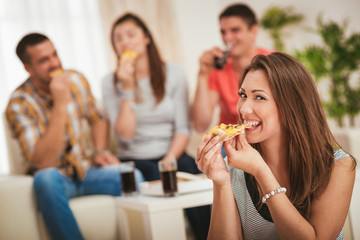 Young Woman Eating Pizza