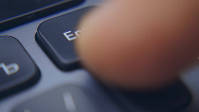 A finger on the black keyboard clicks on the keys  "Enter", "Back", "Delete", "Arrow". Macro. Closeup. Shallow depth of field. Slow mo, slo mo, slow motion, high speed camera, 240fps, 250fps