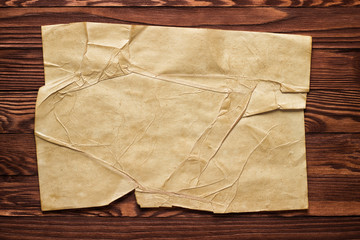 Piece of old paper on wood texture background