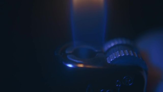 Ignite a cigarette lighter in the hand with a lot of sparks are flying out on black background. S-log - High Dynamic Range. Macro. Extrem closeup. Slow motion, high speed camera, 240fps, 250fps
