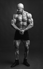 Fototapeta na wymiar Athlete in front pose. Bodybuilder showing muscles and motivating to training.