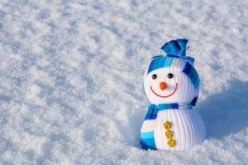 Smiling snowman standing in winter christmas landscape with copy-space.