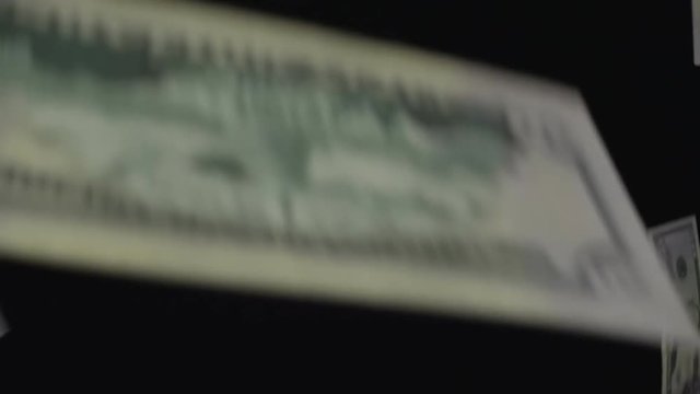 50 dollar bills fall on a black background. Closeup. Slow mo, slo mo, slow motion, high speed camera, 240fps, 250fps
