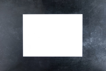 sheet of white paper on black background