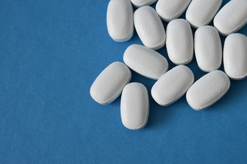 White pills on a blue background