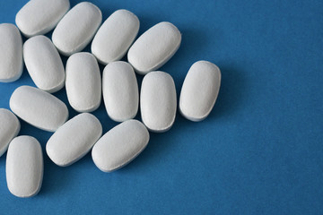 White pills on a blue background