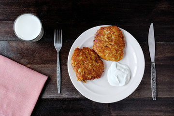 draniki potato pancakes with cream and milk top view